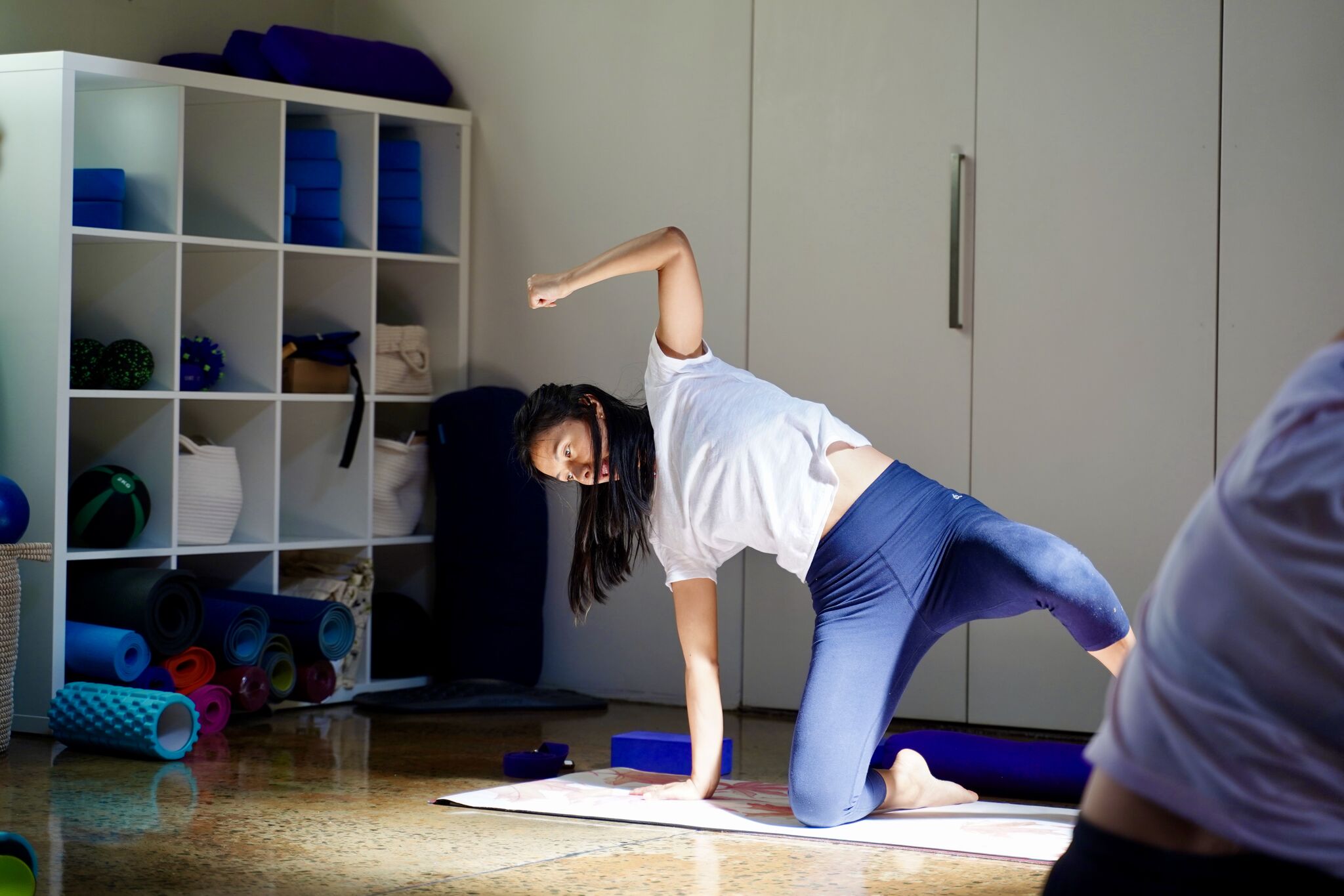 Instructor guiding breath and movement in a calm studio during a nervous system workshop